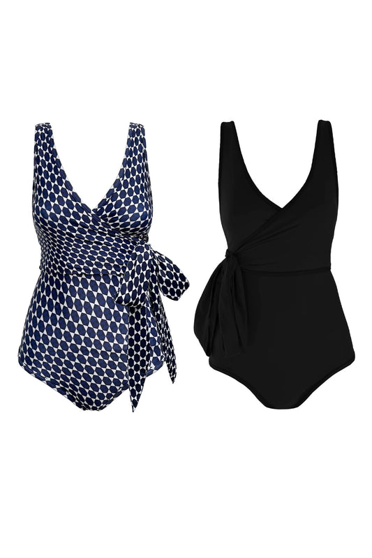Flat lay of a reversible wrapsuit showcasing each side. One side is solid black, the other features a striking geometric mosaic tile-inspired print with navy and white tiles on a white base.