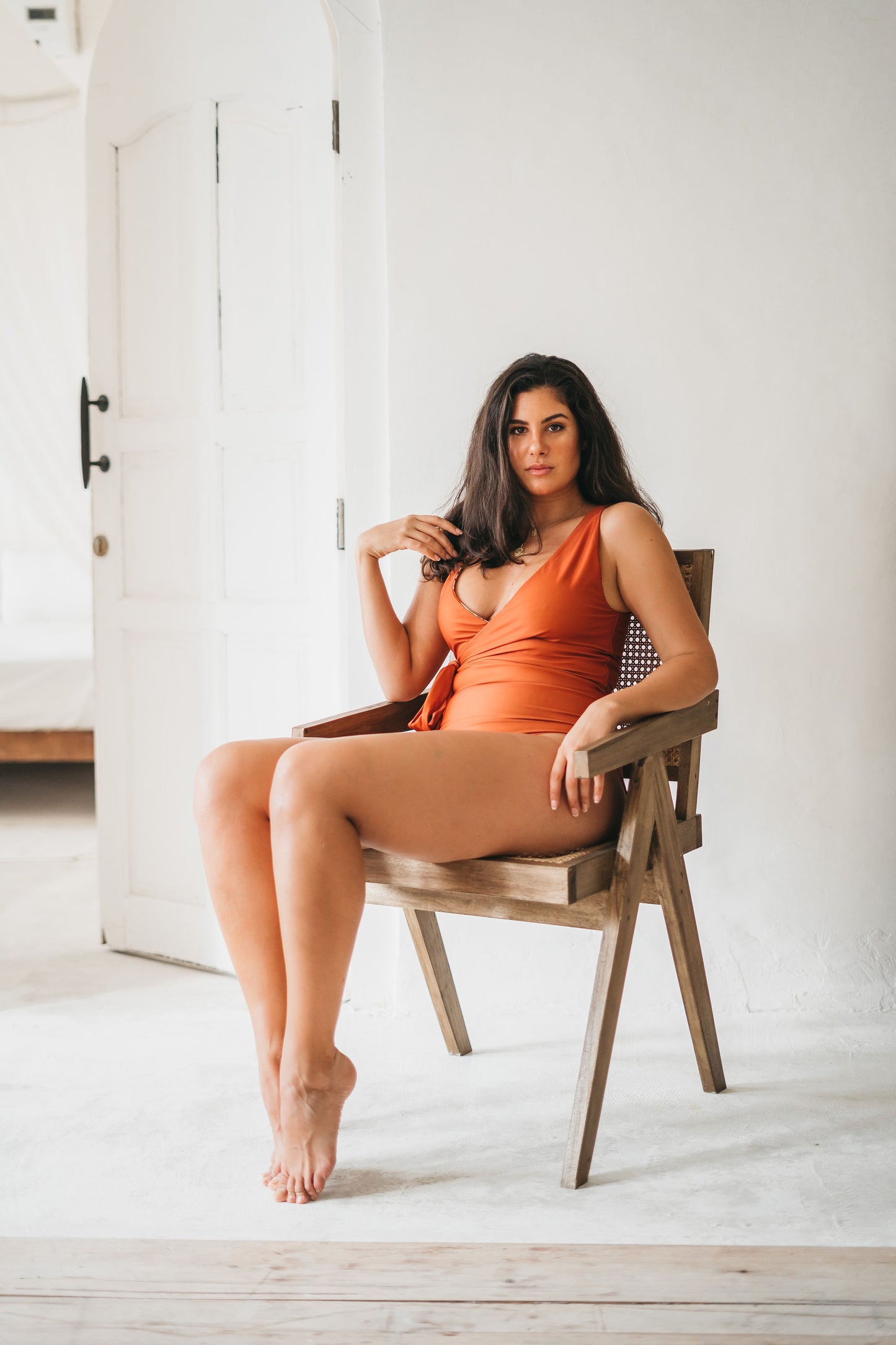 Woman sitting down in sculpting wrapsuit