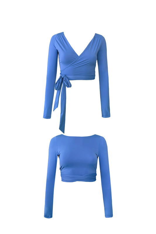 Woman wearing a water lily blue long sleeve wrap top with high waisted bikini bottoms.