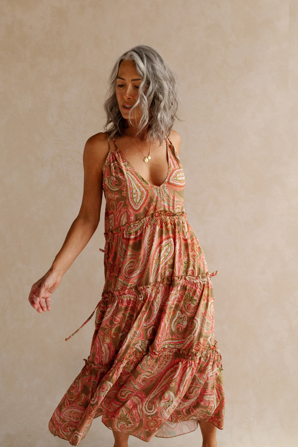 Women swinging in pink paisley summer dress