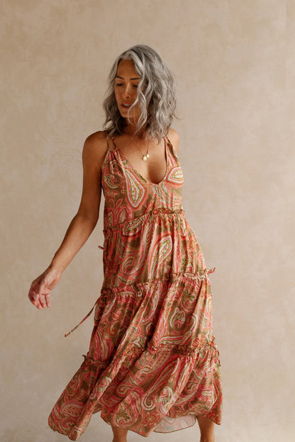 Women swinging in pink paisley summer dress