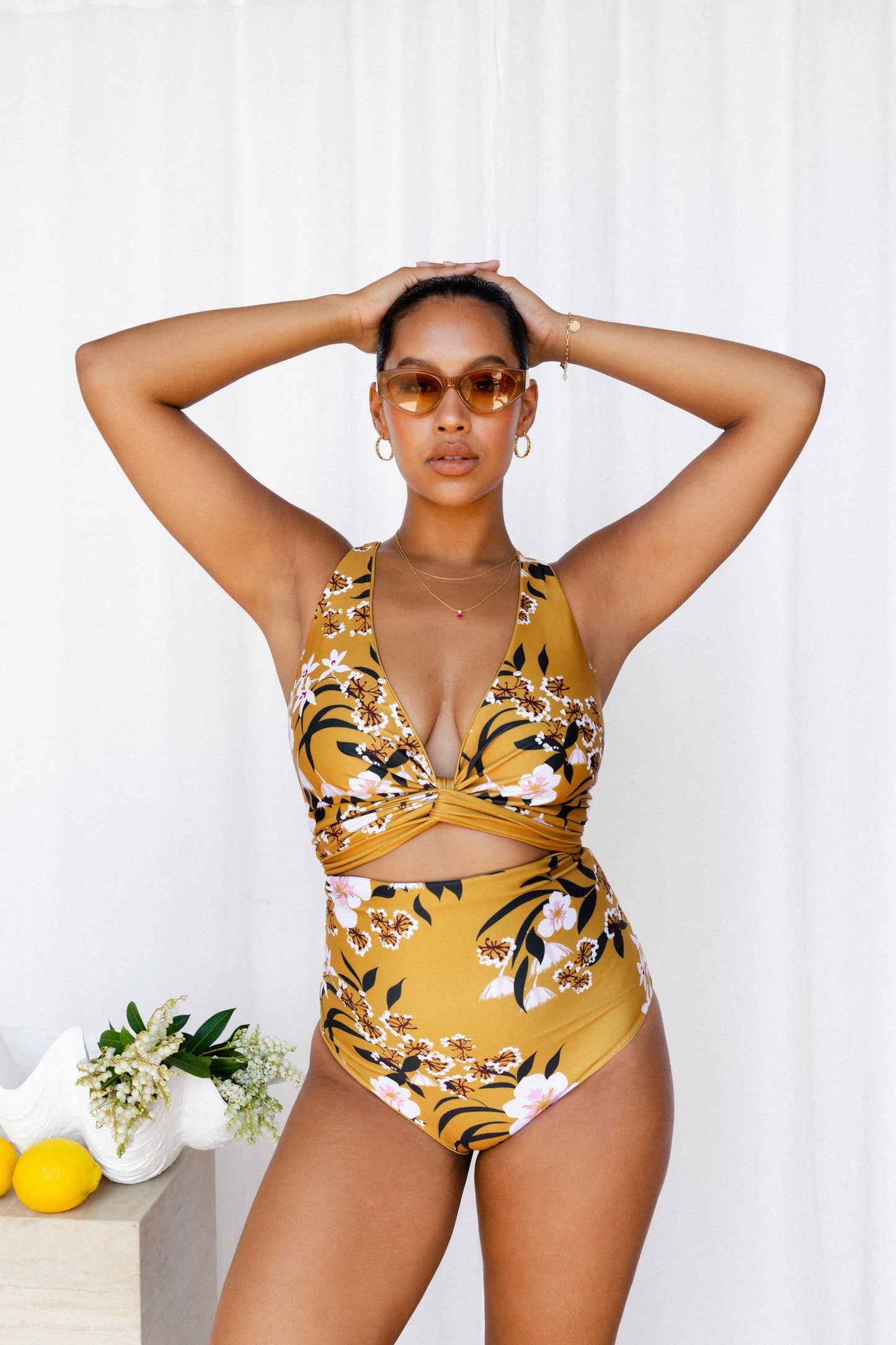 Woman wearing mustard floral bikini.