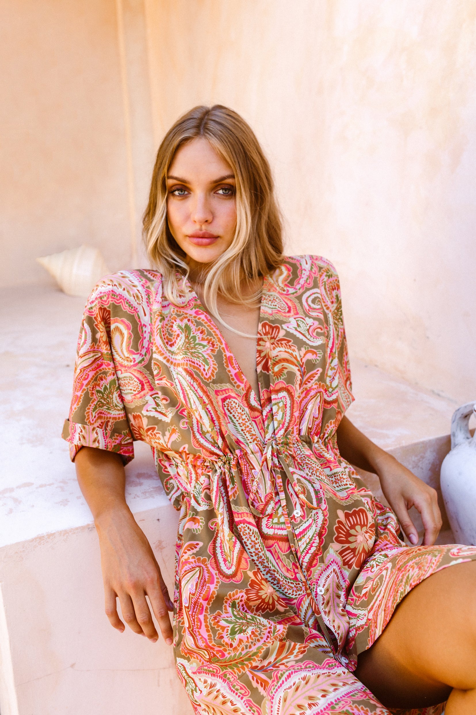 Woman laying back against stone staircase wearing the lightweight Barcelona kaftan dress 
