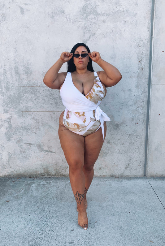 woman wearing white tropical swimsuit for more coverage