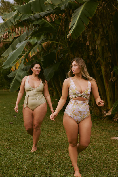 Two women wear reversible pink and green bikinis