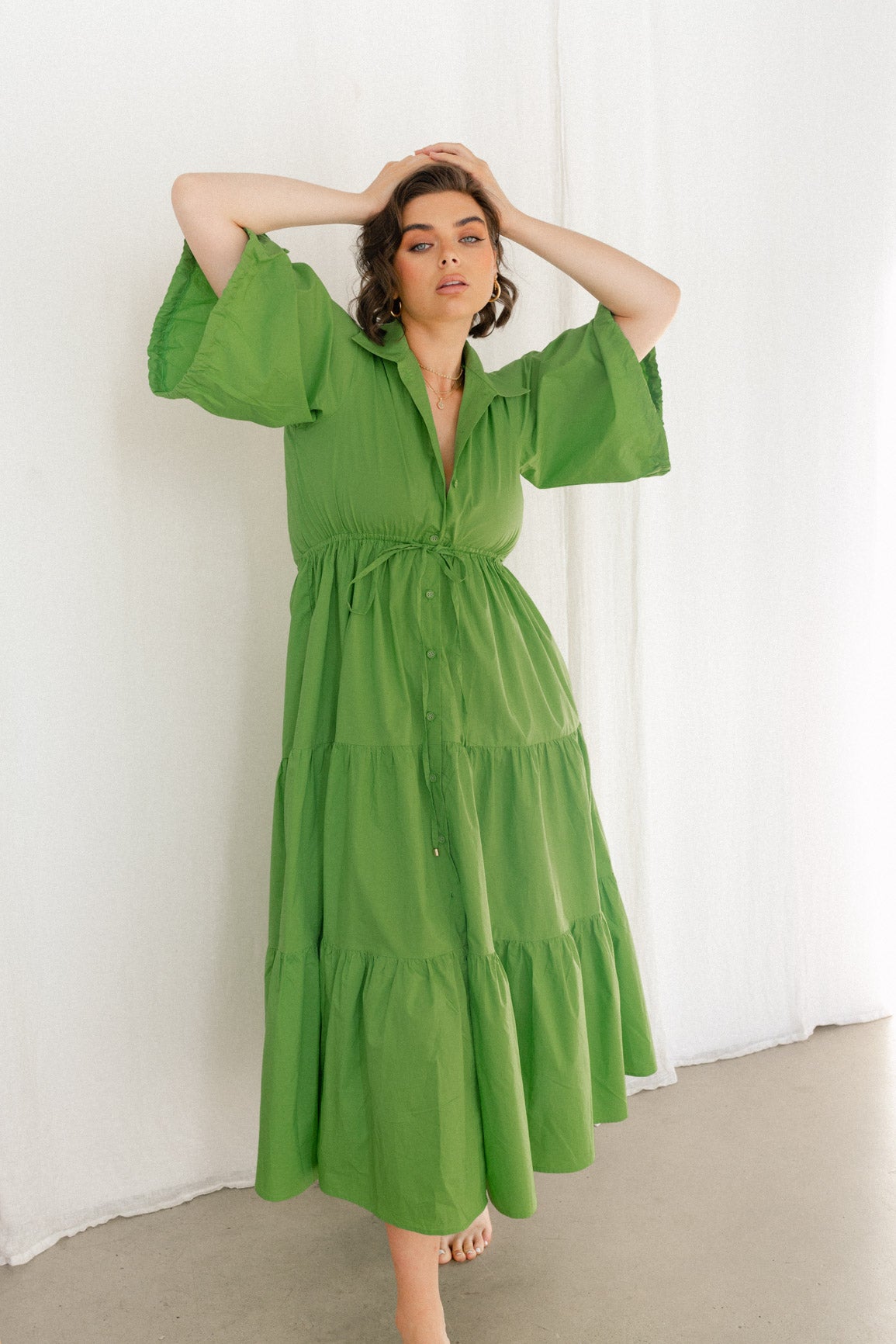 Woman in Green tiered cotton dress 