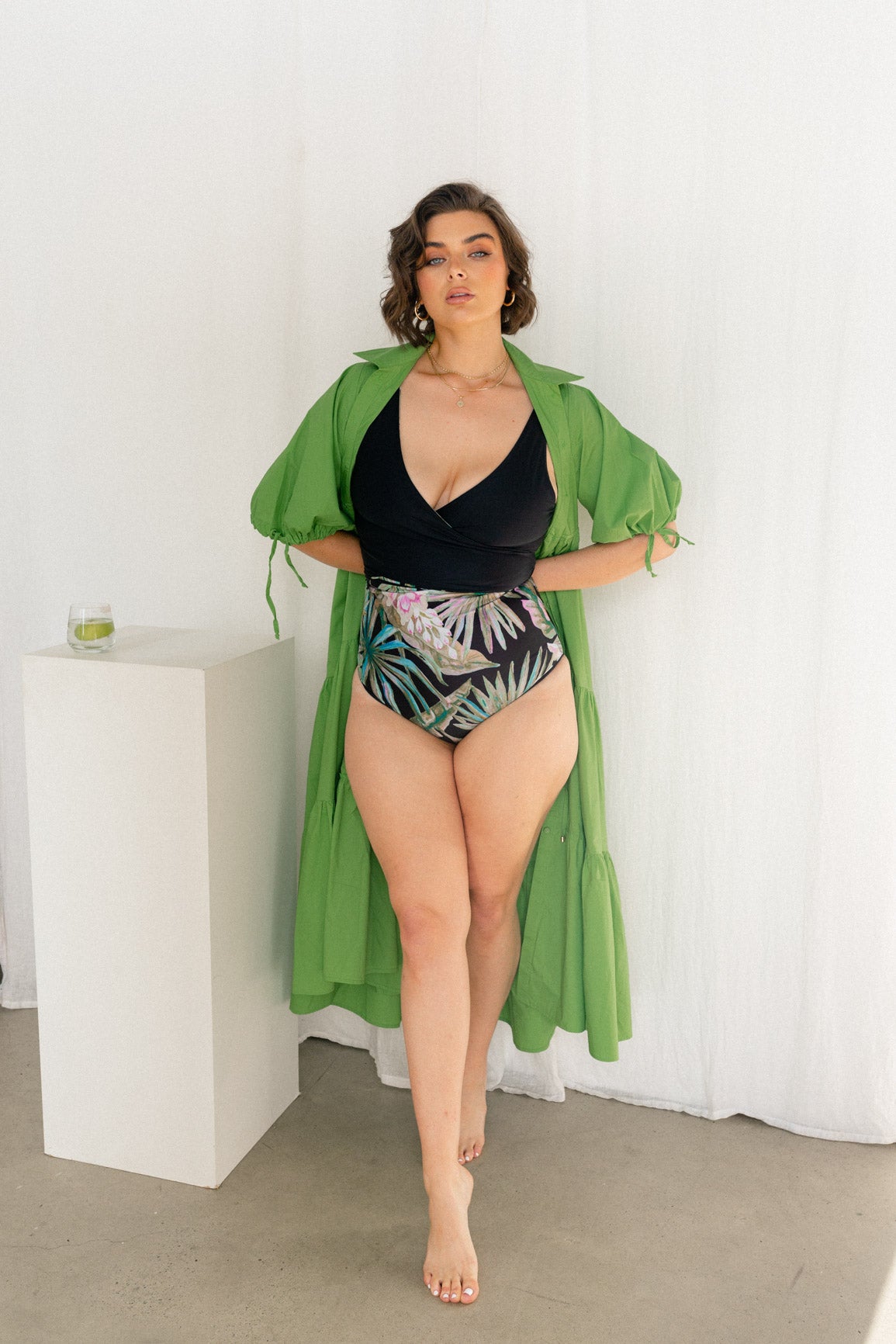 Woman wearing green Harlow dress open over bikini 